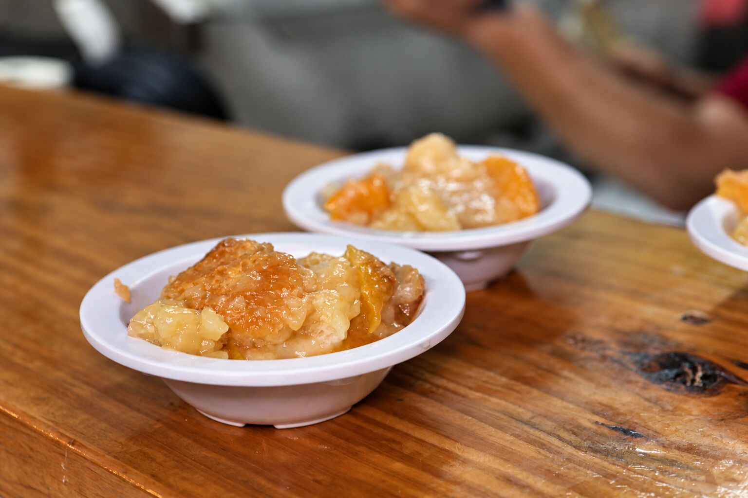 Homemade peach cobbler in a bowl at Brown Chicken Brown Cow